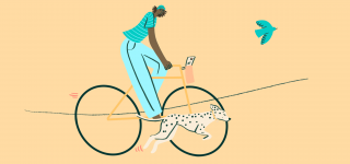 A girl rides her bike with her dog as she learns to be independent, one of the essential life skills for teens.
